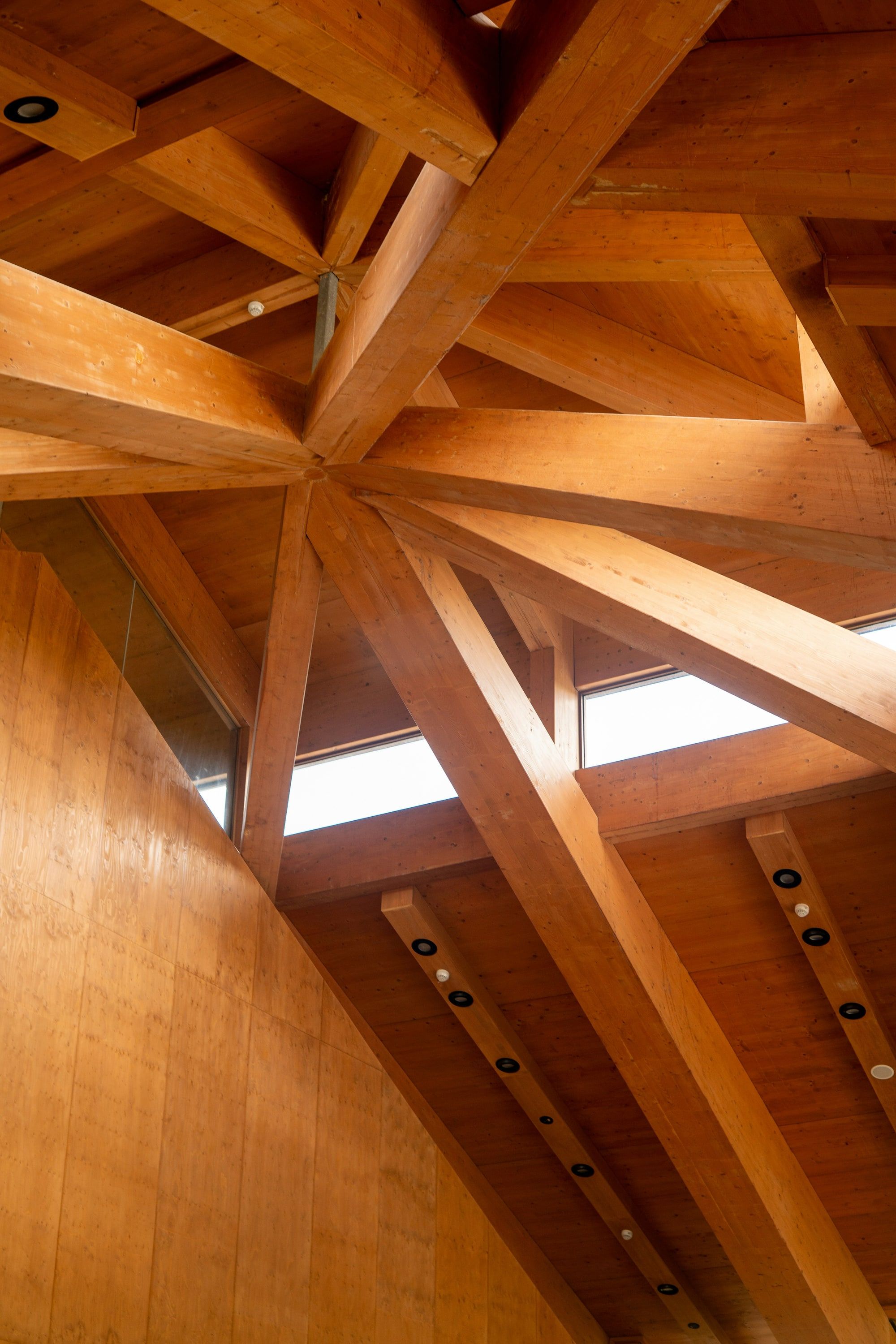 Exposed timber roof beams meeting in a geometric pattern